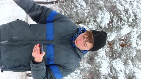 A Young Teenager of Caucasian Ethnicity Stands in a Winter Forest