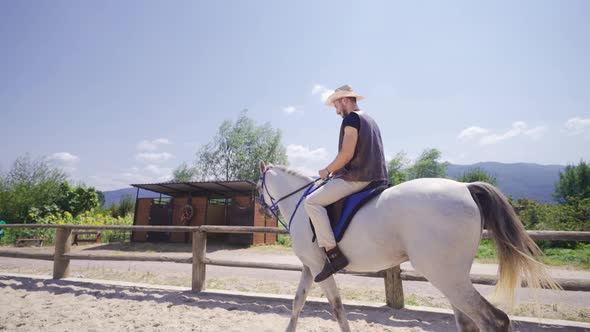 The man who rides on the farm loves horses.