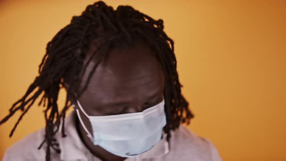 African Man with Face Mask Shaking His Braided Hair