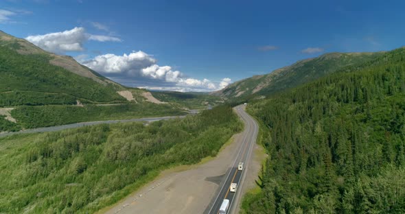 Mountain Road Traffic in Alaska on a Sunny Day alt