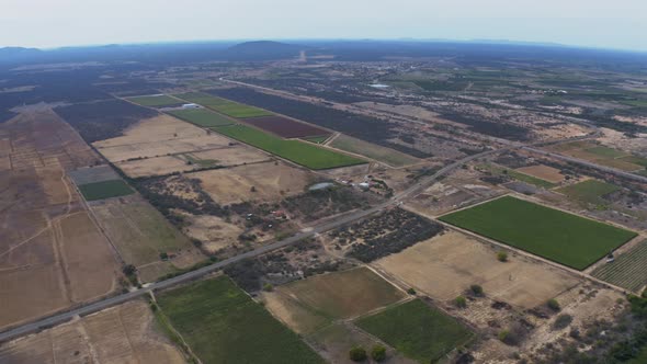 Incredible high altitude aerial view of farm fields and plantations in rural Brazil.