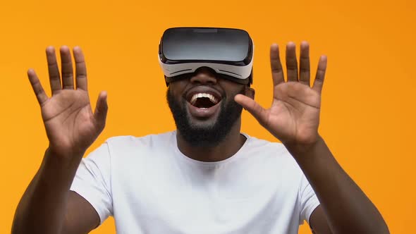 Amazed African Male Wearing Virtual Reality Headset, 3d Simulation Entertainment