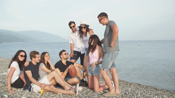 Summer, Holidays, Vacation. Group of Friends Having Fun on Beach Together