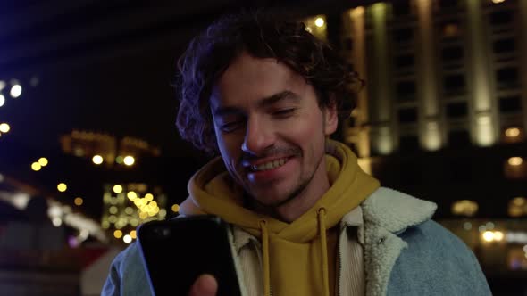 Smiling Man Sending Air Kiss to Phone Camera