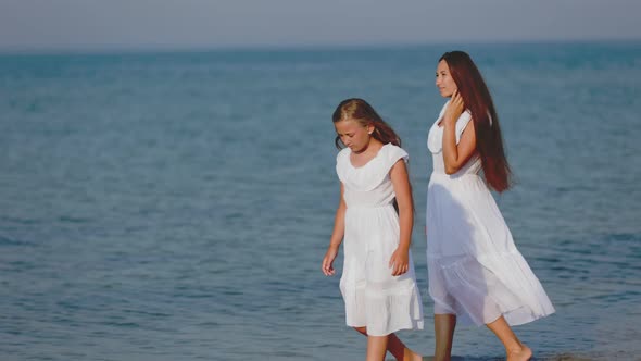 Mom and Daughter are Walking Near the Sea