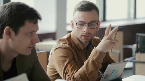 Portrait of Young Attractive Man at Business Meeting with Boss. People Discussing New Project in