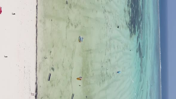 Zanzibar Tanzania  Vertical Video Kitesurfing Near the Shore of Ocean Slow Motion