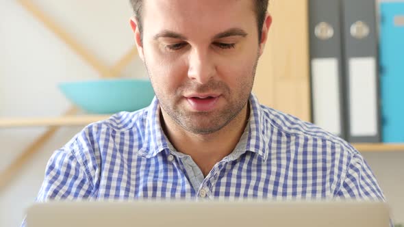 Thumbs Up By Man Working in Office