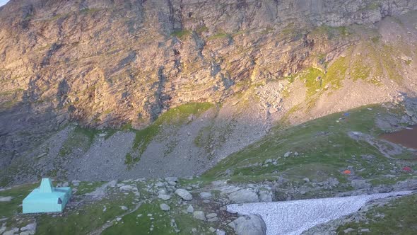 Base camp tent before summit. Resting place for climbers making ascent to top of mountain. Sunset li