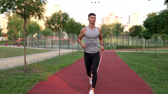 Energetic Man Running on Run Track in the Park Sport