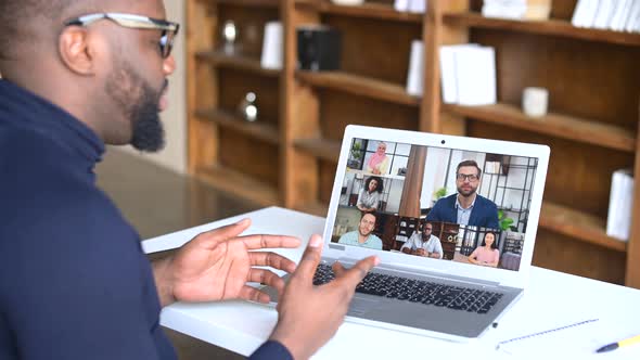 Side View of Black Businessman Talking to His Colleagues Online