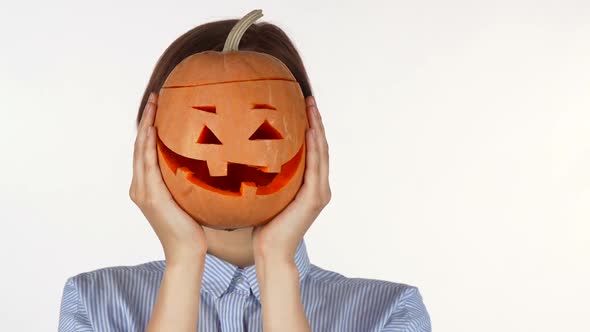 Beautiful Woman Smiling Joyfully Holding Up Halloween Pumpkin