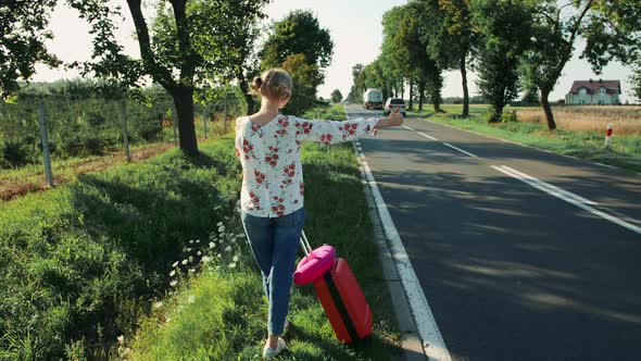 Anonymous Young Lady Hitchhiking on Countryside Road