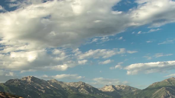 Static time lapse of a cloudscape over rugged mountain terrain of the Rocky Mountains in summer