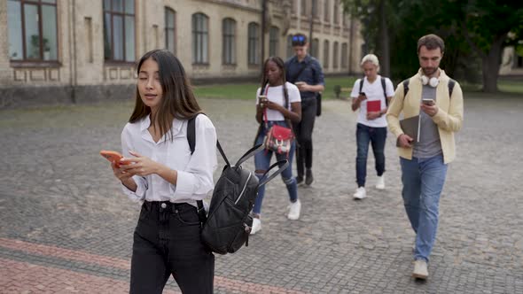 Addicted to Gadgets Students Walking Outdoors