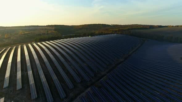 Aerial Drone Footage. Flight To Solar Station Farm at Sunset Autumn Season