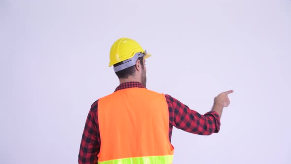 Rear View of Bearded Persian Man Construction Worker Directing and Pointing Finger