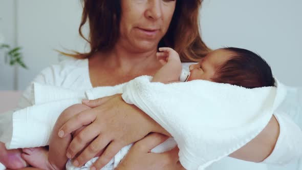 Front view of Caucasian mother holding her newborn baby in the ward at hospital