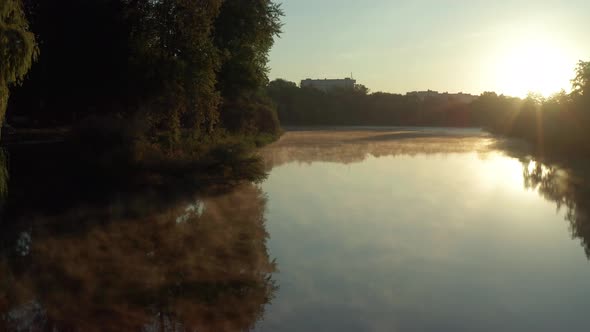 Beautiful morning, summer flight over the river. Fog, trees.