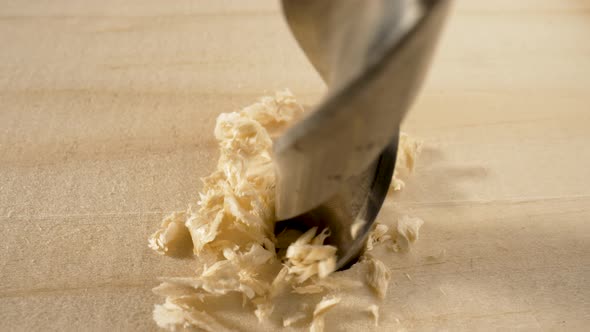 Detail of a Drill Bit Drilling Into Wood Board