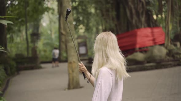 Tourist With Camera In Monkey Forest