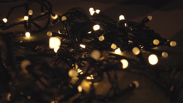 Closeup Shot Hank of Christmas Garland with Golden Lights on a Playd