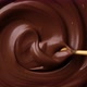 Hand stirring melted dark chocolate with golden spoon - VideoHive Item for Sale