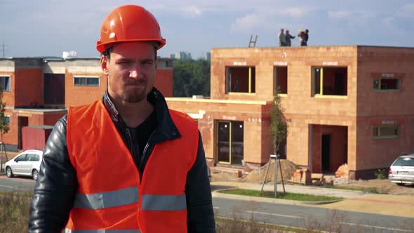 A Young Construction Worker Shows a Thumb Down To the Camera and Shakes Head