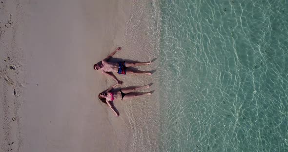 Romantic couple on honeymoon vacation enjoy life on beach on white sand background 4K