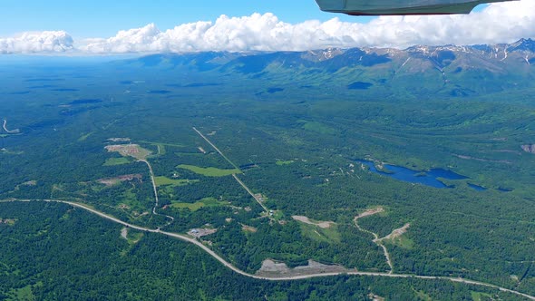 Small airplane flight over the Matanuska River near the Town of Palmer Alaska with the Talkeetna Mou