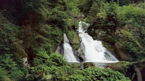 POV Walking Toward Beautiful Waterfall in Forest Wilderness