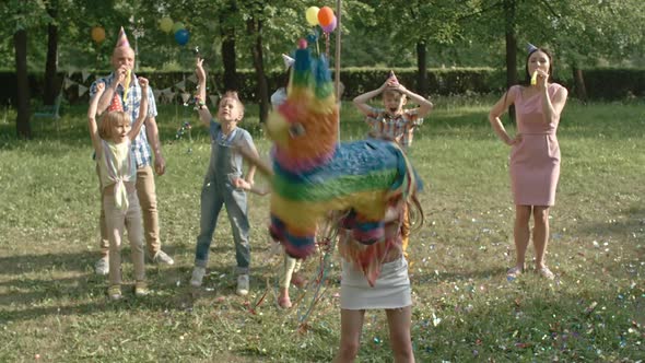 Girl Hitting Happy Birthday Pinata with Bat