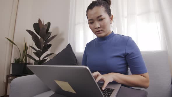 Businesswoman authentic shot using a laptop to work from home happily