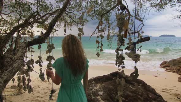 Woman Walking Alone on Beach and Relax Among the Tree Hung with Designer Dry Corals