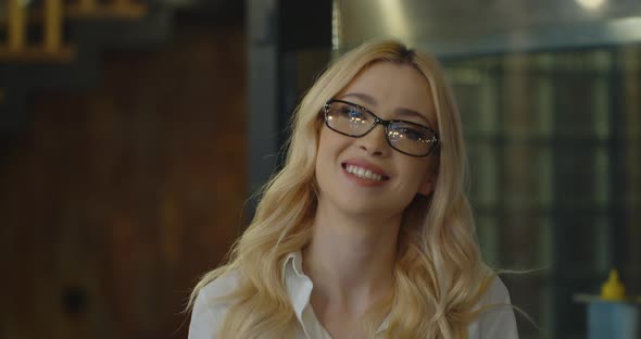 Portrait of Friendly Blonde Business Woman Looking at Camera Smiling Confident Wearing Glasses