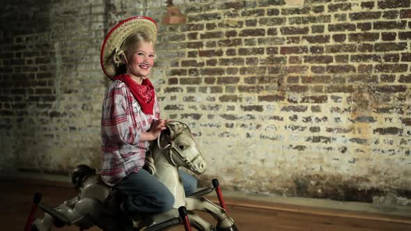 Young girl rocking on rocking horse