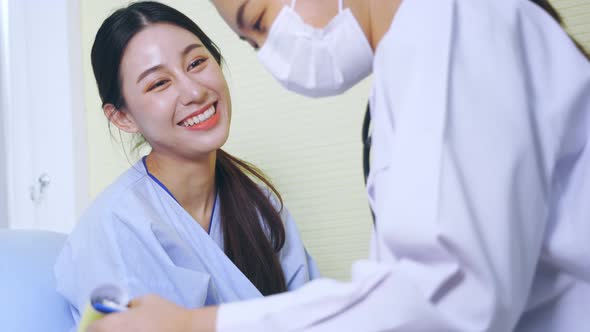 Smiling Patient Talking to Doctor