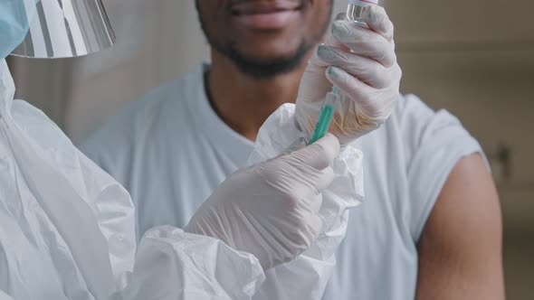 Young Afro Male Patient African American Man Smiling Says Yes Satisfied Looking at Hands in Latex