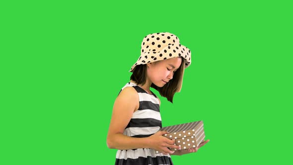 Cute Asian Girl Opening a Gift Box and Happy About What She Find Inside on a Green Screen Chroma Key