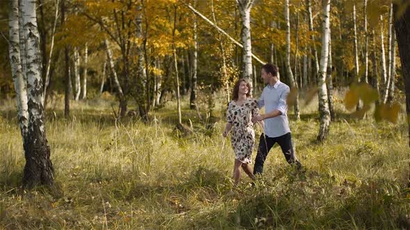 Young Couple Walking on a Meadow