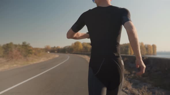 Runner Exercising In Sportswear Preparing To Triathlon And Sprinting Challenge. Running Competition.