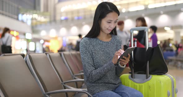 Young woman use of smart phone in airport