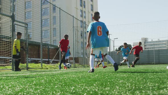 Soccer kids playing in a sunny day