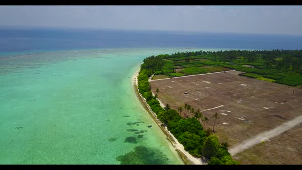 Aerial top down landscape of beautiful coastline beach holiday by turquoise lagoon with bright sand 