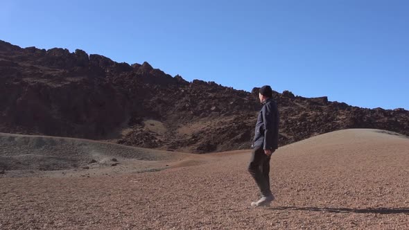 Man Walking Through Dry Moon Like Location