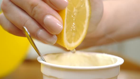 squeezing the lemon into the custard