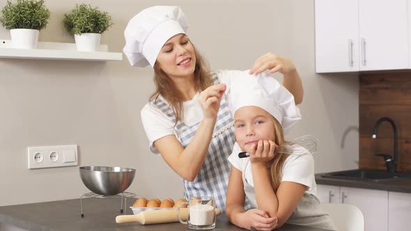 Young Blond Woman and Child Before Baking Cake