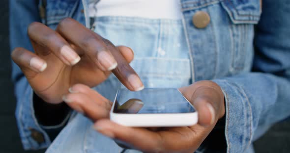 Woman Using Mobile Phone While Leaning Against Wall 4k