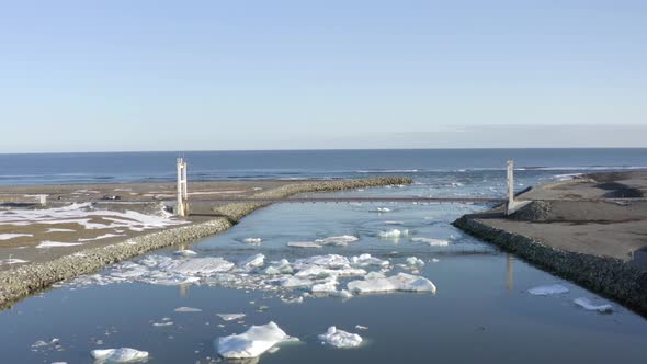 Views From Glacier Lagoon out to Sea with Icebergs in the River and Bridge