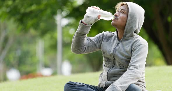 Homeless man drinking water